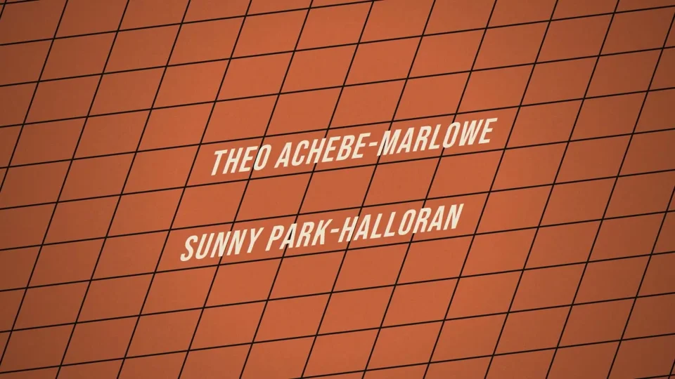 Slanted credit names glide over an orange grid