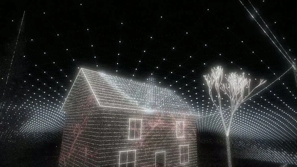 Glowing particle-wireframe house under a starfield of dots
