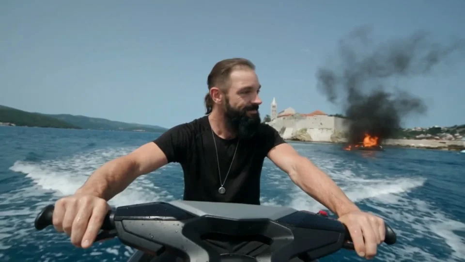 Jet-ski rider flees a burning boat in an agent trailer